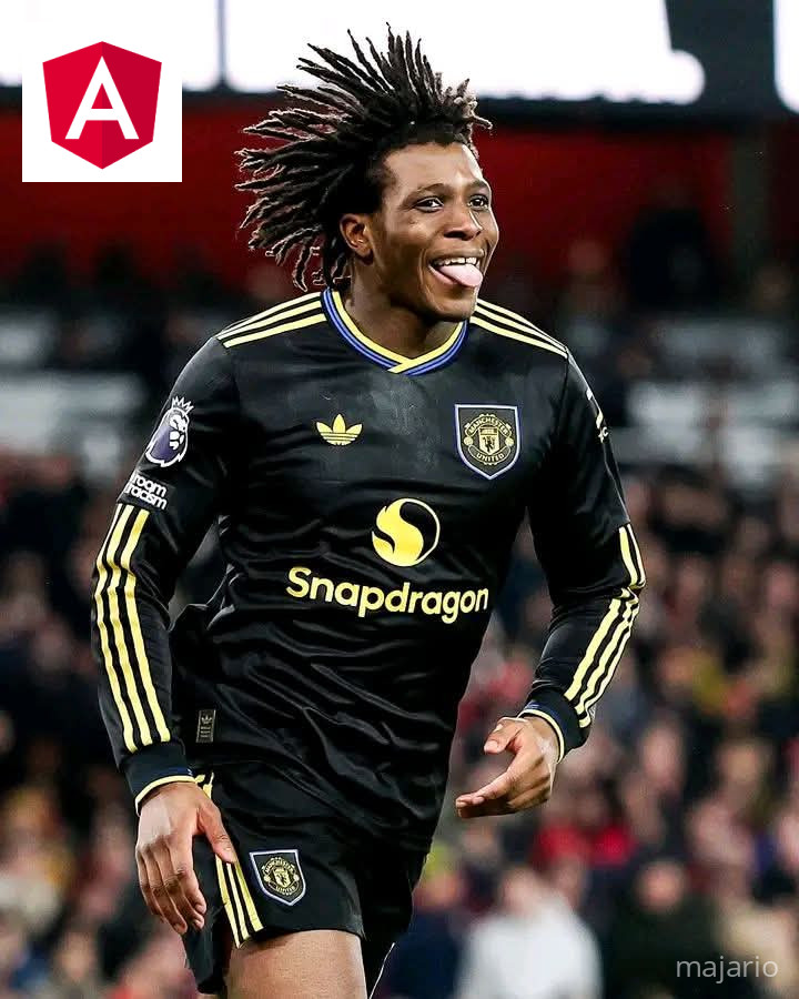 A person in a purple dress is cooking over an open fire inside a rustic kitchen with stone walls and a small window.